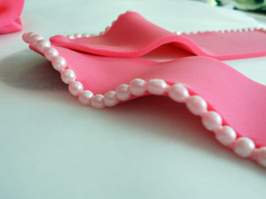 Adding pearl/bead trim to the bow